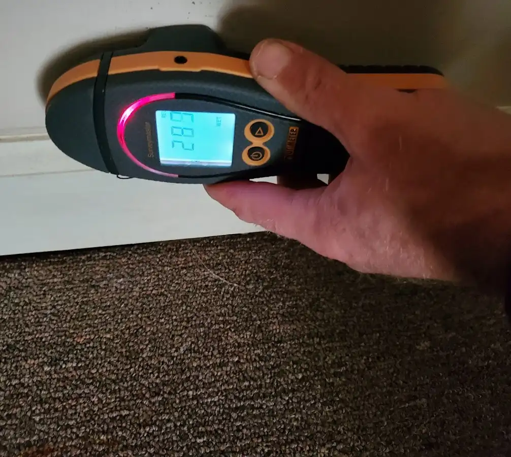 Moisture detection at baseboard during Storm Damage Restoration in Waukesha